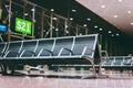 Empty seats bench in the airport hall near departure gate at international airport. Waiting for boarding at night Royalty Free Stock Photo