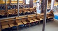 Empty seats and bookshelves at college library