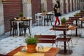 Empty seats at cafe terrace tables