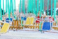 Empty seats of childrens carousel in a cloudy day