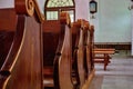 Empty seats for people in a Catholic Church. Details of religious architecture Royalty Free Stock Photo