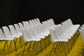 Empty seats in rows audience room white chairs yellow floor Royalty Free Stock Photo