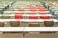 Empty seats with tables in a conference hall