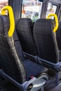 Empty seats with yellow handles in a minibus