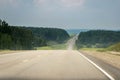 Empty Section Of Countryside Highway With Distant Traffic Of Cars, Trucks Before Summer Thunderstorm.