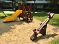 The teeter-totters on the sandpit nearby the slide.