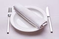 Empty served restaurant table with white tablecloth