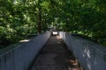 Empty Shaded Bridge at Dellwood Park in Lockport Illinois with Green Trees during Summer