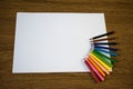 Empty sheet of paper and color pencils on the table stock photo Royalty Free Stock Photo