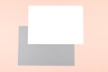 Empty sheets of white and gray paper on pink background. Royalty Free Stock Photo