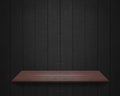 Empty shelf at black wooden wall background Royalty Free Stock Photo