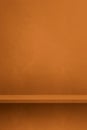 Empty shelf on an orange brown concrete wall. Background template. Vertical mockup Royalty Free Stock Photo