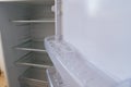 empty shelves of the open refrigerator. household appliances Royalty Free Stock Photo