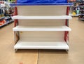 Empty shelves in the store. Laying out goods in a supermarket