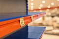 Empty shelves in supermarket, closeup. Product deficiency due to social panic