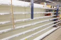 Empty shelves in the supermarket after rush demand during the epidemic. Text in Russian: millet, bean