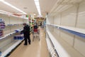 Empty shelves of toilet paper in a supermarket