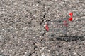 Empty shopping cart beside the asphalt crack