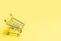 Shopping cart on yellow background Royalty Free Stock Photo