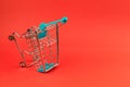 Empty shopping cart on bright red background Royalty Free Stock Photo