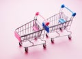 Empty shopping carts on pink background Royalty Free Stock Photo