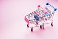 Empty shopping carts on pink background Royalty Free Stock Photo