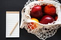 Empty shopping list next to a string bag of fruits Royalty Free Stock Photo