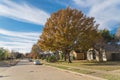 Empty sidewalk and quite neighborhood street with row of suburban house and colorful fall foliage in Texas, USA Royalty Free Stock Photo