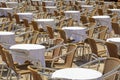 Empty sidewalk tables and chairs in a sunny summer day