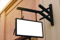 Empty signage and blank mock up hanging on street with copy space Royalty Free Stock Photo