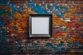 An empty silver photo frame hanging on a colorful, graffiti-covered brick wall in an urban setting
