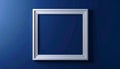 Empty Silver Picture Frame on a Textured Deep Blue Wall with Subtle Lighting Royalty Free Stock Photo
