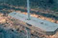 Empty single-rope swing on a rope. Wooden swing and rope with a knot. Close-up. Selective focus Royalty Free Stock Photo