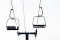 Empty ski chairlift covered in snow set against white background Royalty Free Stock Photo