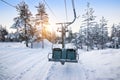 Ski lift at sunrise in the beautiful snowy nature of Lapland.