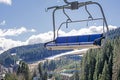 empty ski lift over ancient spruce trees. Royalty Free Stock Photo