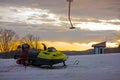 Empty ski lift and snowmobile during sunrise in a ski resort Royalty Free Stock Photo