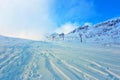 Empty ski lifts among snow-covered mountains and snowdrifts,ski slopes are not cleared and not ready for tourists Royalty Free Stock Photo