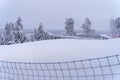 Empty ski slope, side view with blue net Royalty Free Stock Photo