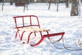 Empty sleigh in snowy park on sunny winter day Royalty Free Stock Photo