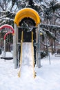 Empty slide in snow covered park