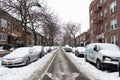 Snow Covered Residential Street in Astoria Queens New York during Winter with Homes and Parked Cars Royalty Free Stock Photo
