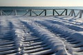 Empty snow covered terrace of a cafe near the sea in winter Royalty Free Stock Photo