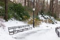 Empty Snow Covered Trail with Benches and a Street Light at Central Park in New York City during Winter Royalty Free Stock Photo