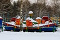 Empty snowy cold children`s carousel, attraction in the park in winter Royalty Free Stock Photo