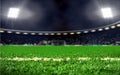 Soccer field stadium with green grass and bright spotlights at night Royalty Free Stock Photo