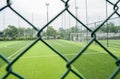 Empty soccer ground with wire fence in cloudy summer