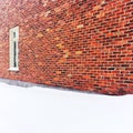 Empty space covered by snow near a brick wall Royalty Free Stock Photo