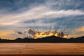 Empty space of plank wooden table, perspective view, blurred background of the mountainscape and wide blue sky at sunset, golden Royalty Free Stock Photo