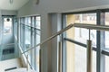 An empty space with railings and large windows. The modern interior of the lobby of the office building. A lighted long corridor Royalty Free Stock Photo